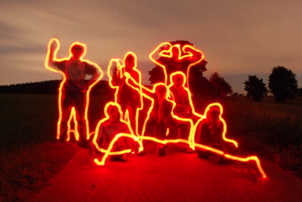 A red torch exposure picture outlining people in the frame.